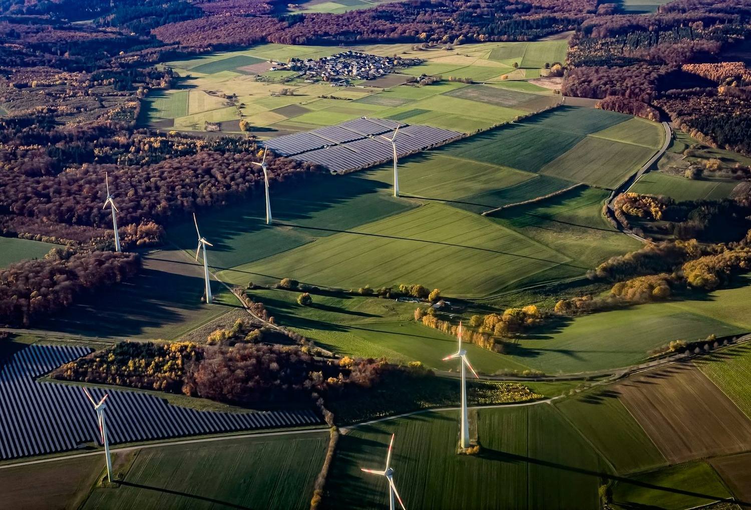 Vindturbiner og solcellepark i et landskap